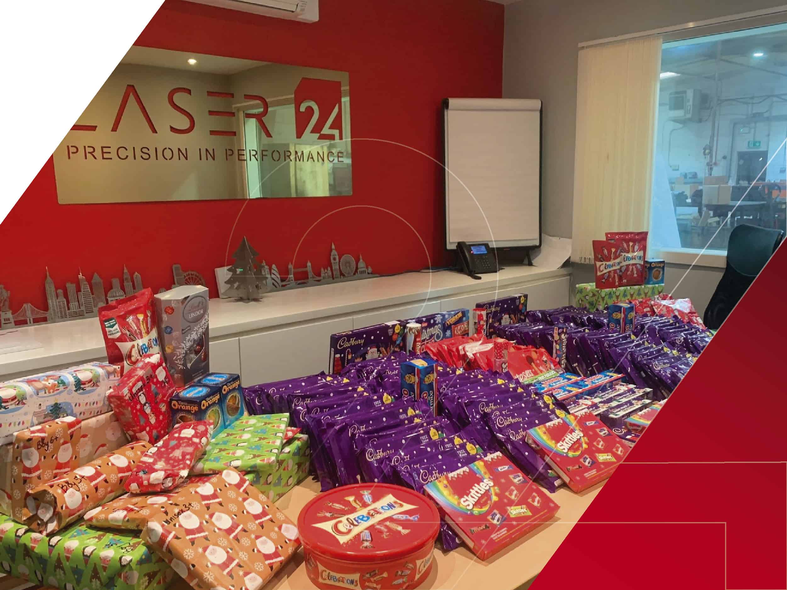 Laser 24 table full of gifts and chocolate for charity